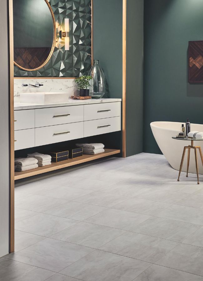 gray luxury vinyl tile flooring in a modern bathroom with dark green walls