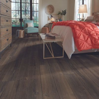 dark luxury vinyl plank flooring in a cozy bedroom